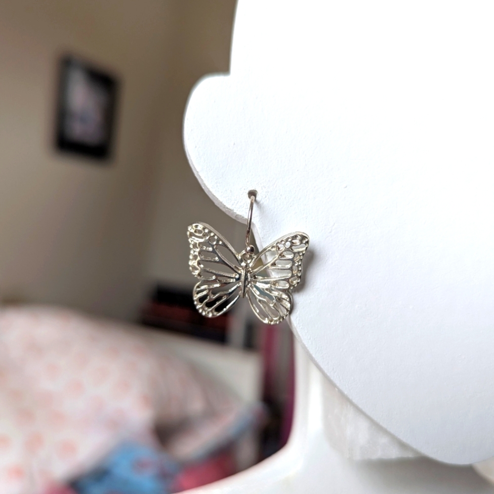 Silver tone mini butterfly earrings. Hook style